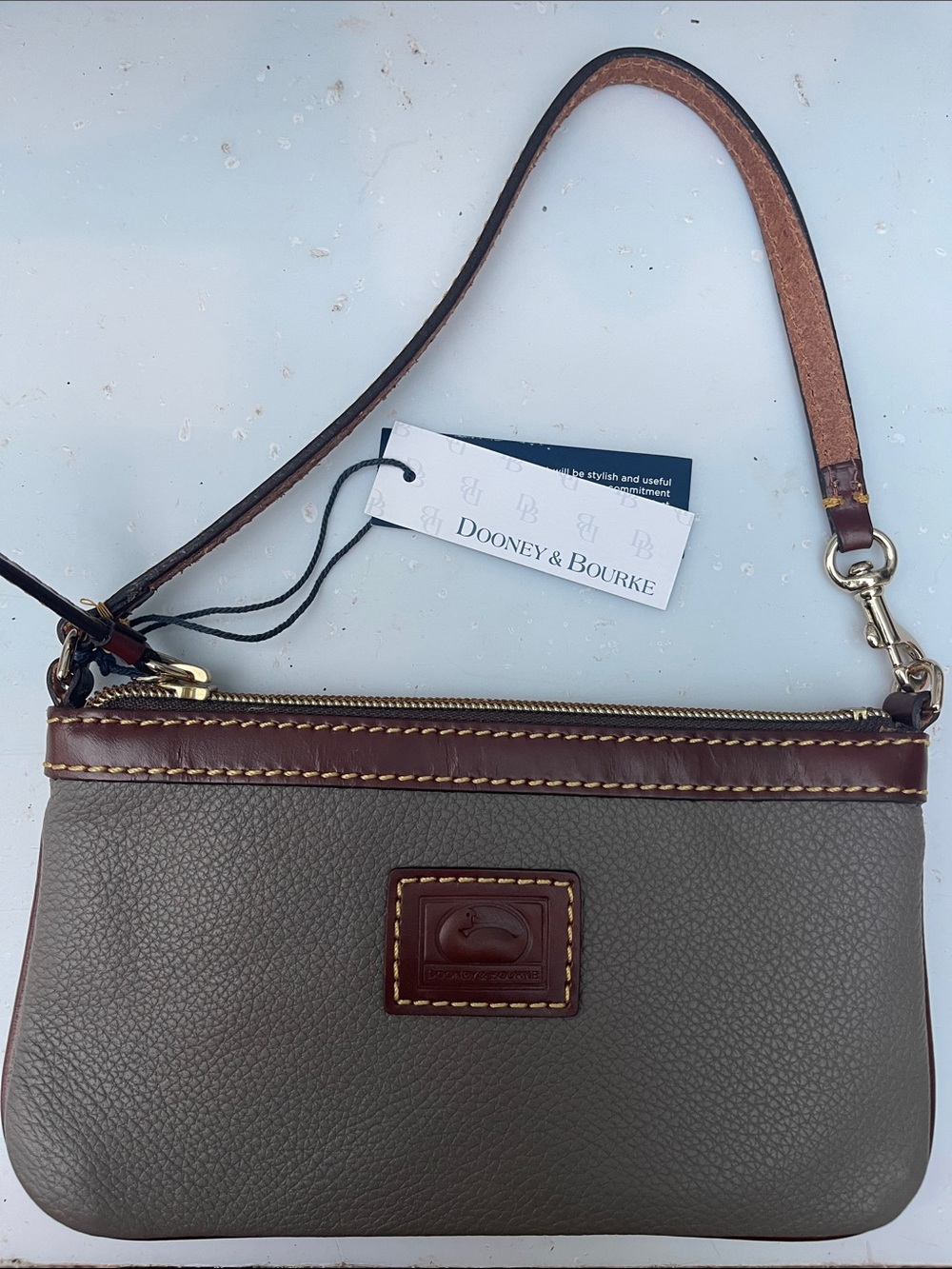 NWT Dooney & Bourke Pebble Grain Large Slim Wristlet in the color Smoke